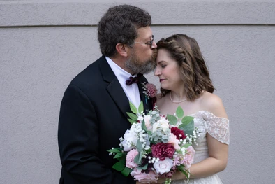 Dad kissing his daughter on the forehead at her Omaha wedding