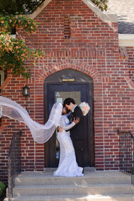 Bride & groom in front of a Fremont church, taken by an Omaha wedding photographer