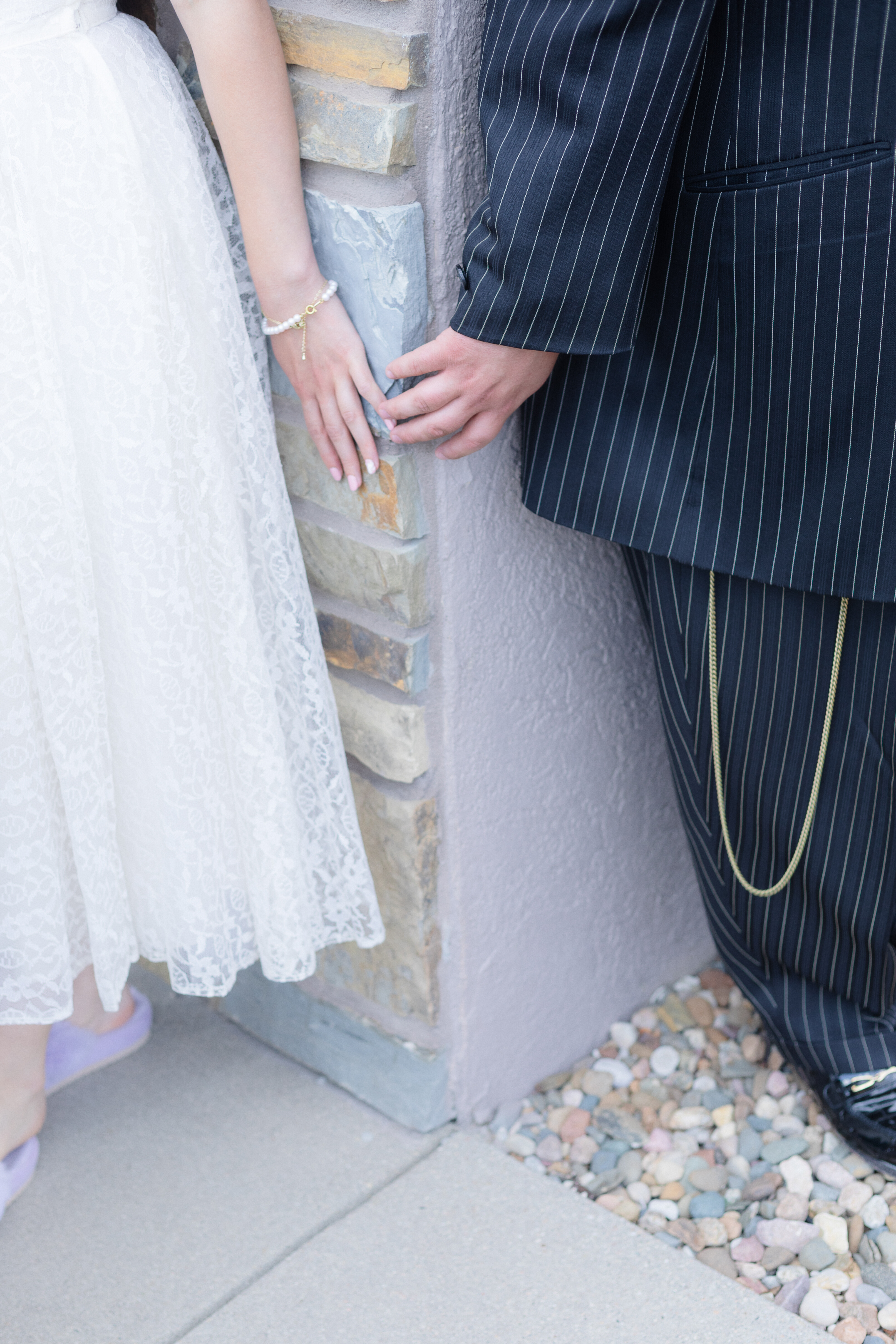 Hands of a bride and groom reaching toward each other during their Omaha wedding